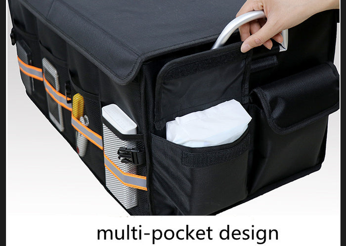 A car trunk storage organizer box with items inside of it