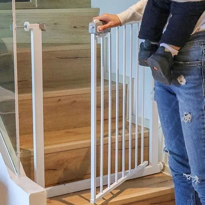 A person opening Children Safety Gate which is installed on a staircase