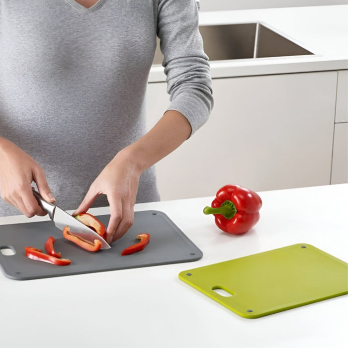 Someone is Cutting Food On Chopping Board Set.