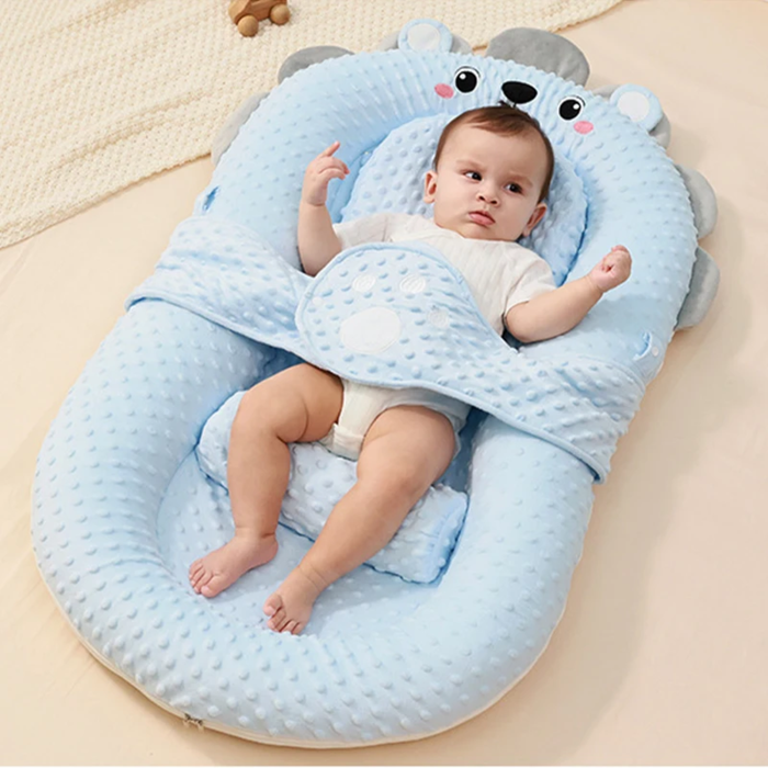 A Baby is lying down on the Comfortable Baby Nest Bed.
