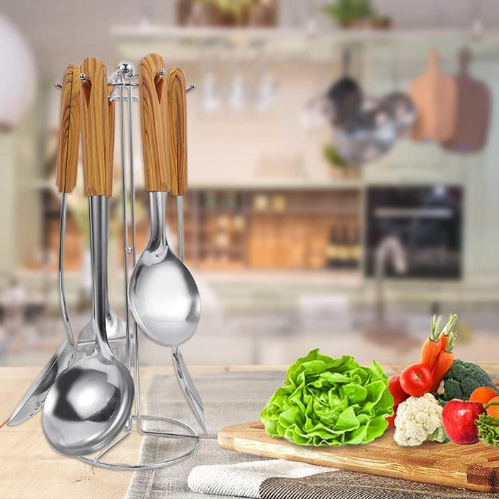 Cooking Spoon Serving Tools are organized in a stand placed along with veggies.