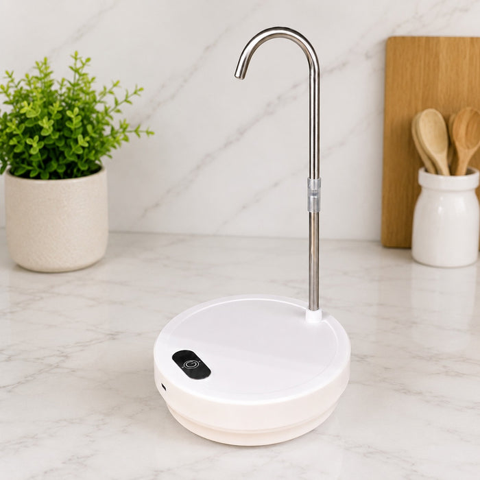 A Desktop Dual-Use Electric Water Pump with a curved stainless steel spout, shown on a white marble countertop with a potted plant and wooden cutting board in the background.