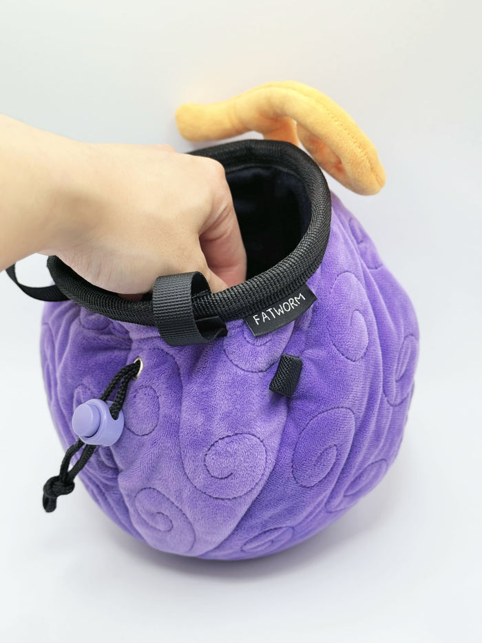 A soft and fluffy Gomu Gomu no Mi (Gum-Gum Fruit) plush chalk bag by Fatworm. This cute yet functional climbing gear features the iconic purple swirl pattern and a long-durable design. The perfect climbing gift for climbers who love unique, handmade gear.
