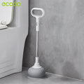 An Ecoco toilet plunger is placed on the bathroom floor beside a toilet.