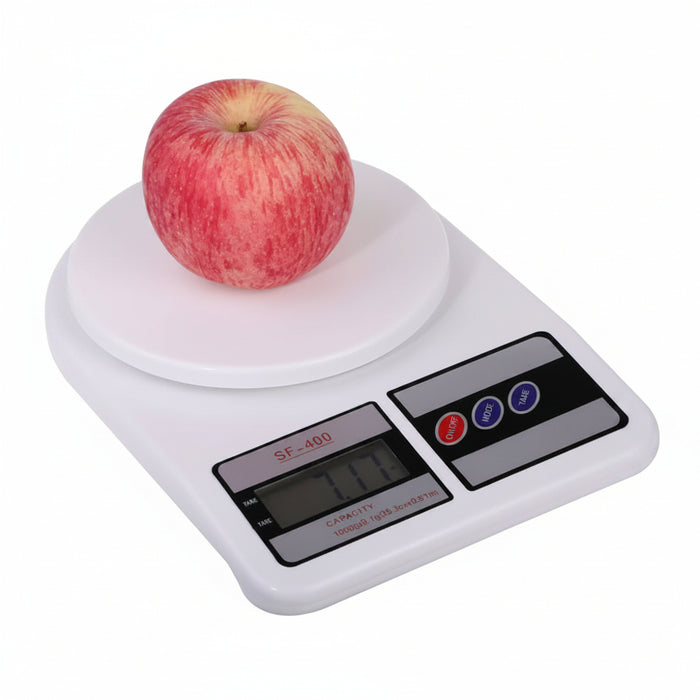 Digital kitchen scale with an apple on a white background