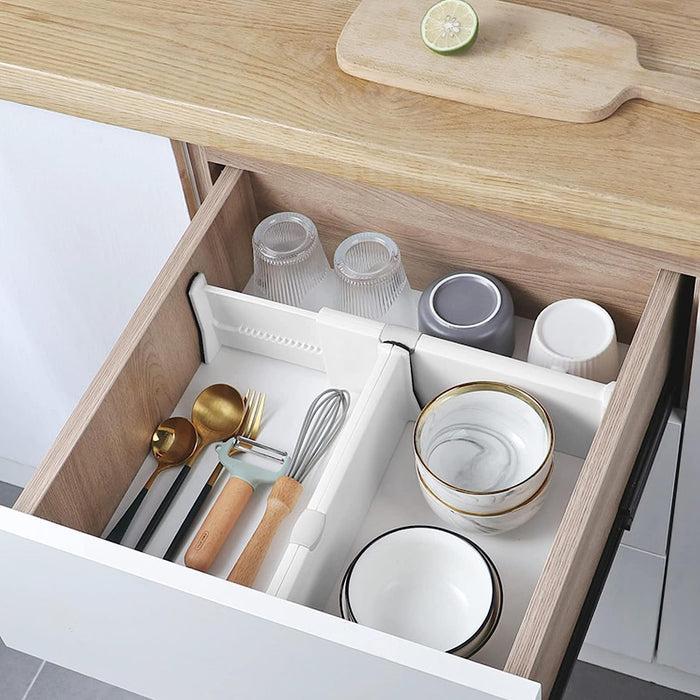 A drawer full of dishes and glasses separated with the help of drawer separator
