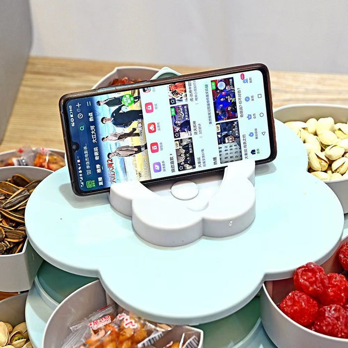 A mobile phone placed on top of Flower Design Snack Box filled with candy and nuts