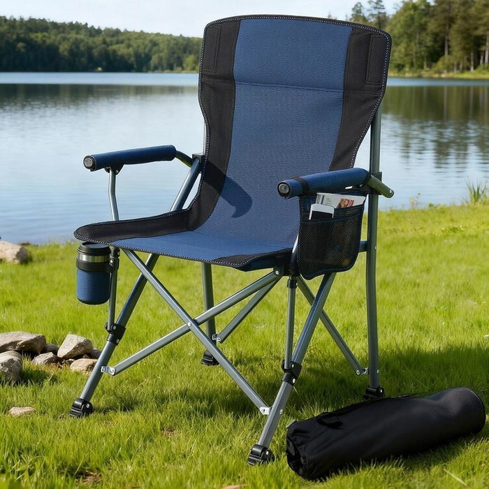 Blue camping chair with cup holder and armrests on grass by a lake