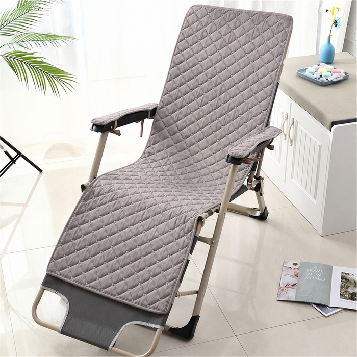 Foldable lounge chair with quilted cover in a room setting