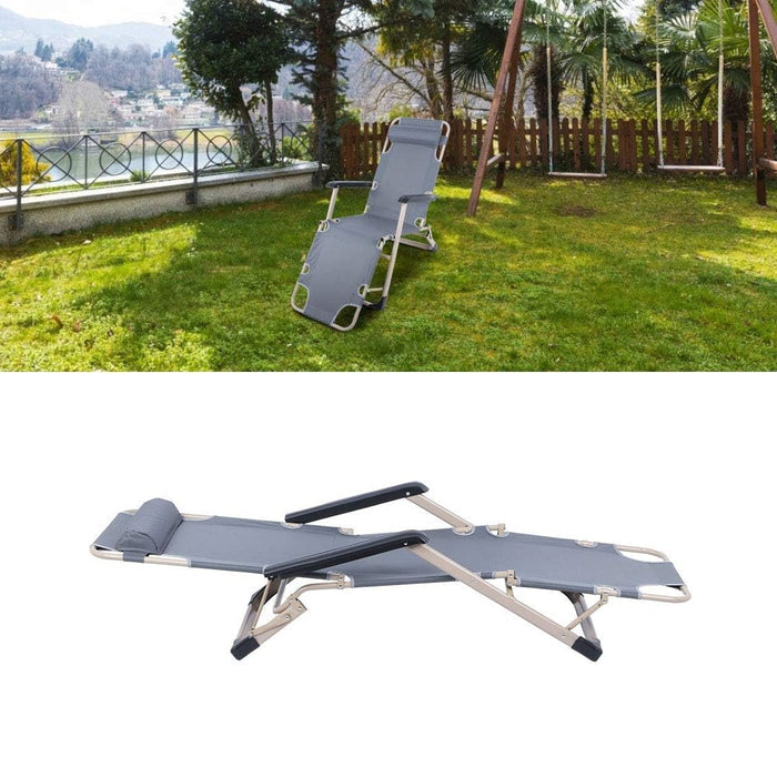 Folding lounge chair on a grassy area with a scenic background