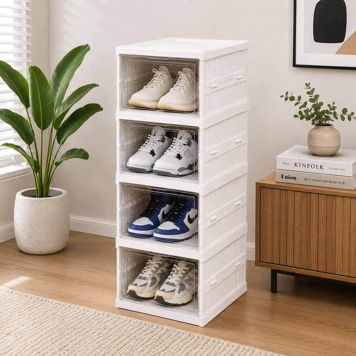 White shoe storage rack with shoes inside, placed in a room with a plant and books on a cabinet.