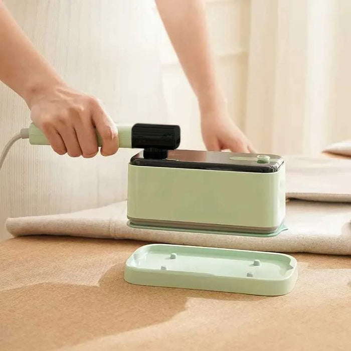 A Person is Ironing Garment Using  Handheld Travel Garment Iron Steamer.