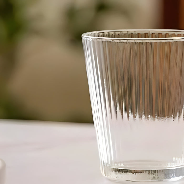 Clear glass from Glass Water Jug & Drinking Glass Set with ribbed texture on a blurred background