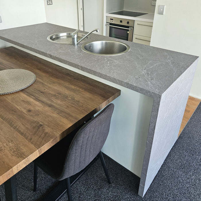 Kitchen interior with a countertop, sink, and cabinets.