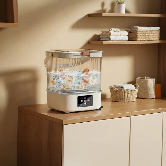 Green Lion 12L Portable Mini Washing Machine with clothes inside on a wooden countertop with shelves in the background