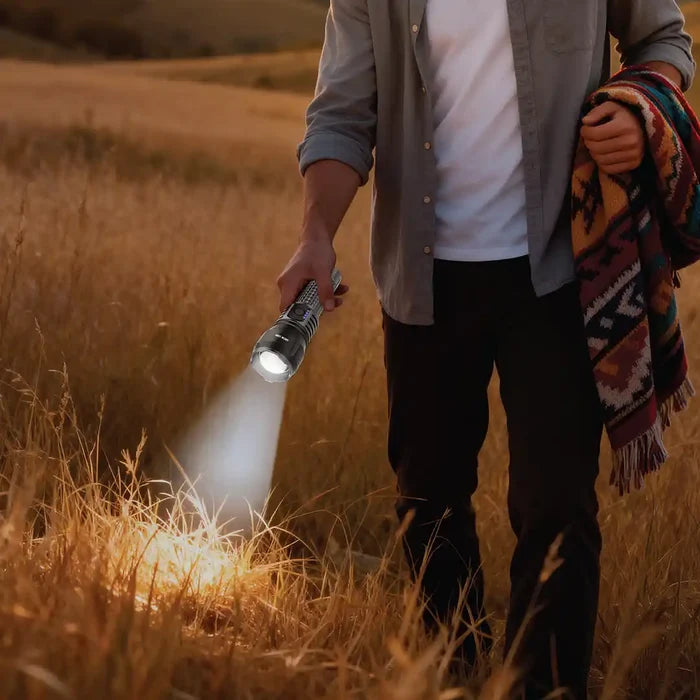 Person holding a Green Lion Hunter Portable LED Torch flash  in a field with a blanket over their shoulder