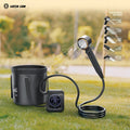 Green Lion Portable Camping Shower with digital display and cup on grass, Green Lion branding visible