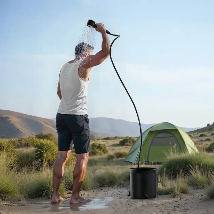 Man showering outdoors with a Green Lion Portable Camping Shower with a tent in the background