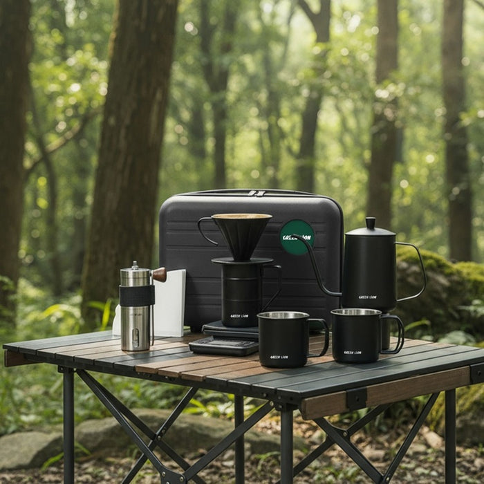 Green Lion V-60 Pro Coffee Maker Set on a wooden table in a forest setting