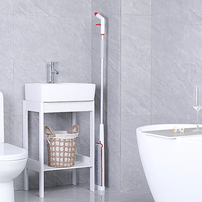 Hands-Free Spray Mop with Self-Wringing Function placed in the bathroom leaning back to the wall