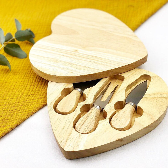 Heart-shaped wooden cheese board with built-in knife storage and serving area.