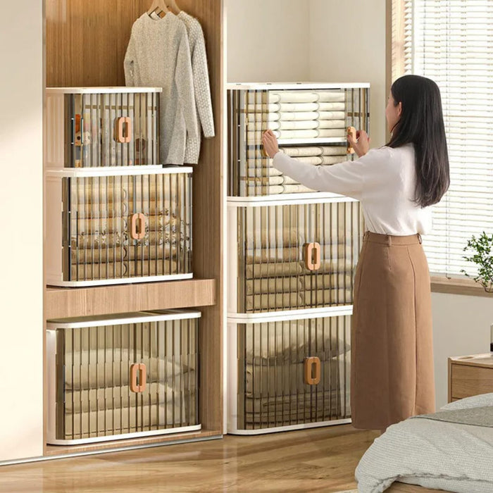 A Woman is Arranging Her Cloths in a Home Storage Bins.