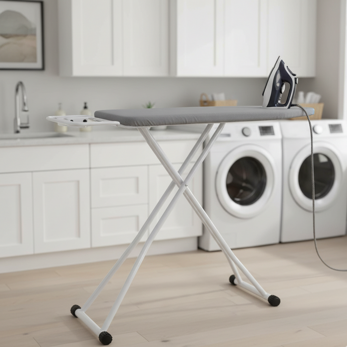 An A Person is Ironing Her Clothes On Iron Board with Iron Holder is Placed  at Laundry Area.