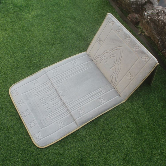 Grey color Islamic Foldable Prayer Mat placed on a grass with backrest opened