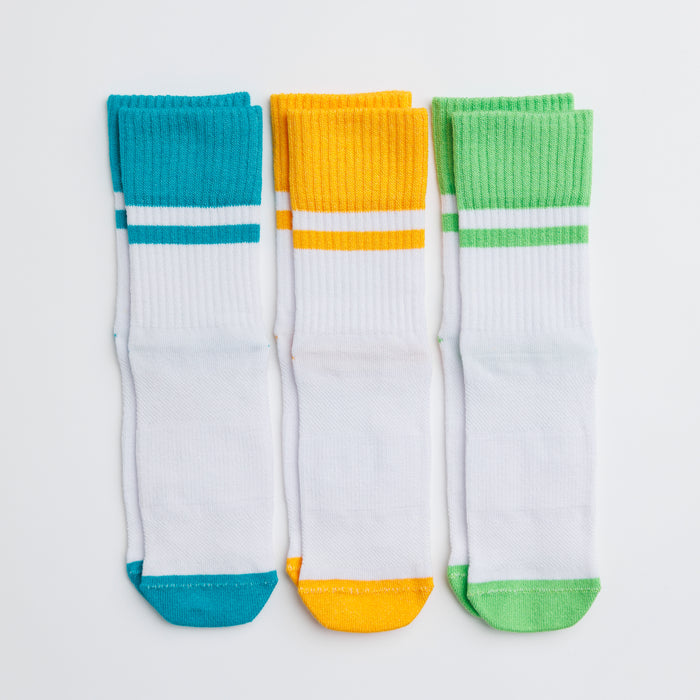 Landyn kids socks: three white socks with teal, yellow and green cuffs and toes. Squid Socks, the brand seen on Shark Tank.