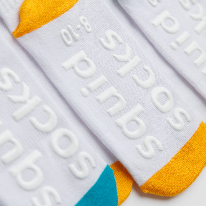 Landyn kids socks: close-up of branded sole grips on a white and yellow sock. Squid Socks, the brand seen on Shark Tank.