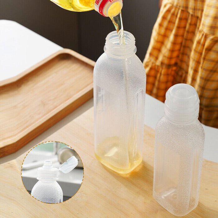 Someone is pouring oil into a Kitchen Oil Spray Injection Press Bottle Sprayer Dispenser
