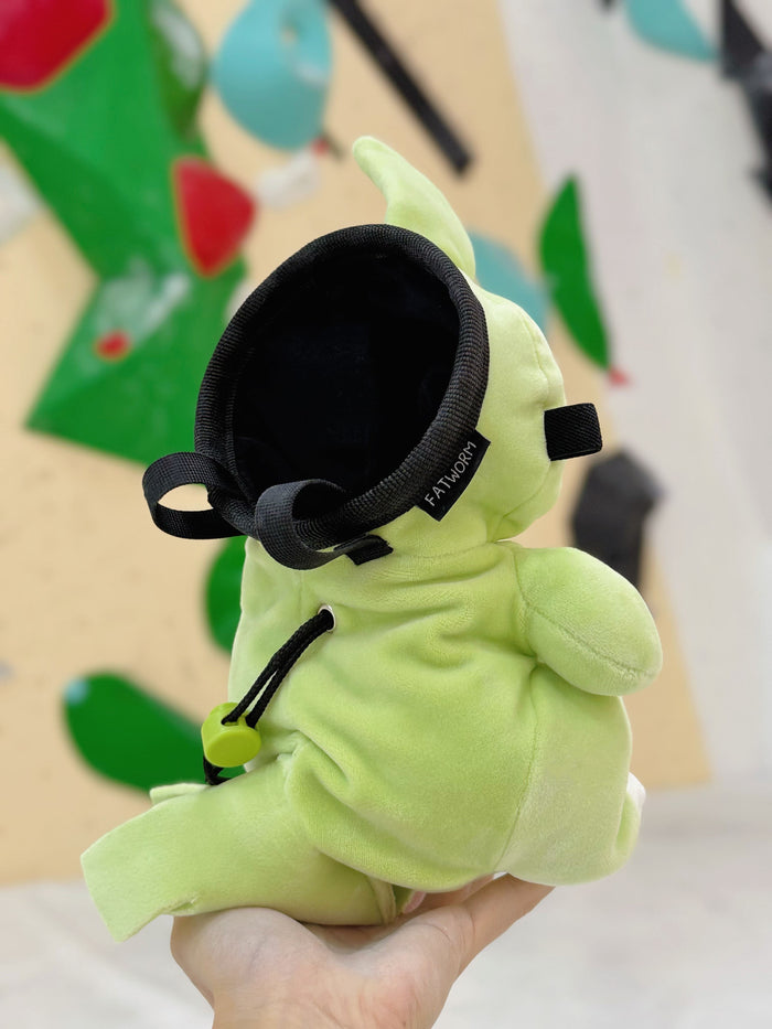 Handmade green and red plush Larvitar rock eater climbing chalk bag with a minimalist mimic face. Cute and unique climbing gift by Fatworm.