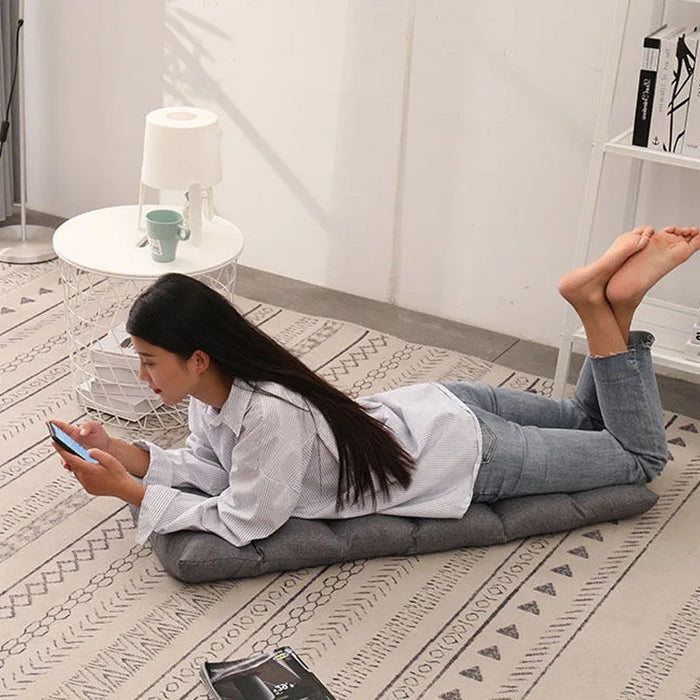 A lady lying on a Lazy Lounge Sofa which is converted to Bed