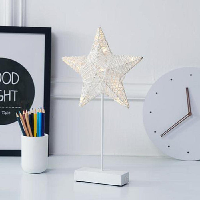 A LED Star Table Lamp Decorative Night Light is Placed on a Table Along with Other Decor Items.