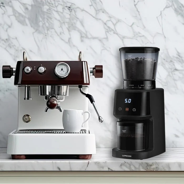 Lepresso AeroGrind Conical Burr Coffee Grinder placed near a home coffee station, set against a marble backsplash.