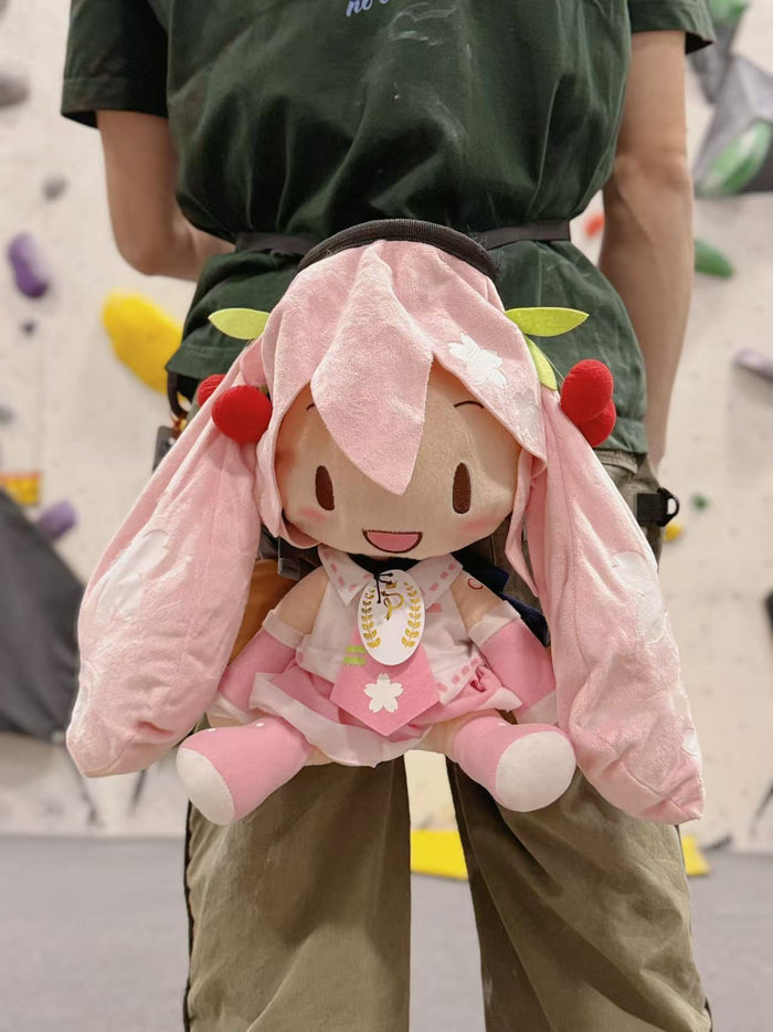 A Limited Edition Sakura Miku plush chalk bag by Fatworm. This soft and fluffy bouldering accessory features a pastel pink cherry blossom theme and long-durable handmade construction. A cute and functional climbing gift for climbers who love unique gear.