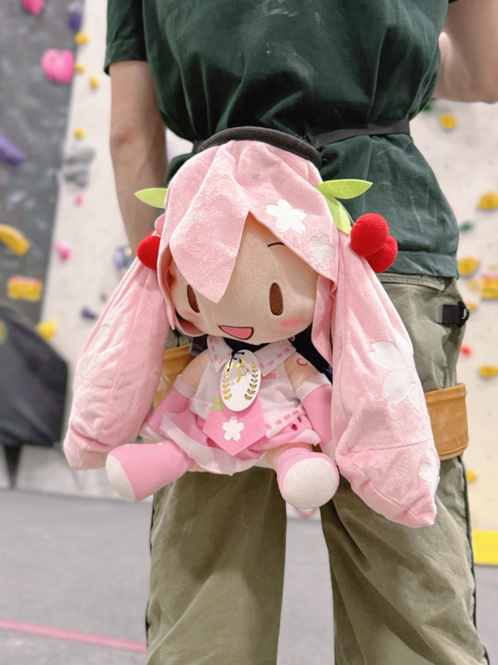 A Limited Edition Sakura Miku plush chalk bag by Fatworm. This soft and fluffy bouldering accessory features a pastel pink cherry blossom theme and long-durable handmade construction. A cute and functional climbing gift for climbers who love unique gear.