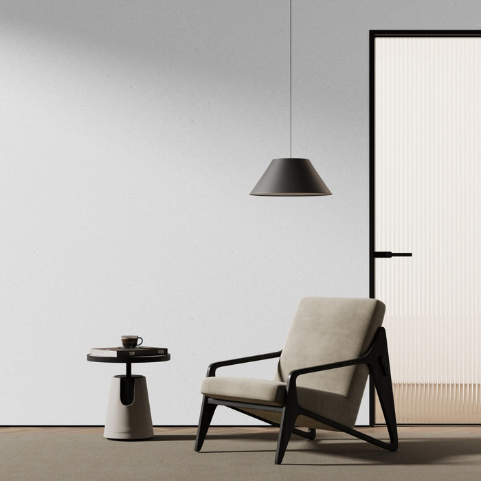 Modern armchair with a side table and pendant light in a minimalistic room with lunar stone micro terrazzo adhesive vinyl on the wall.