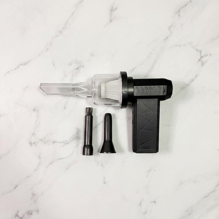 Mini Jet Fan Compressed Air Duster with attachments on a marble surface