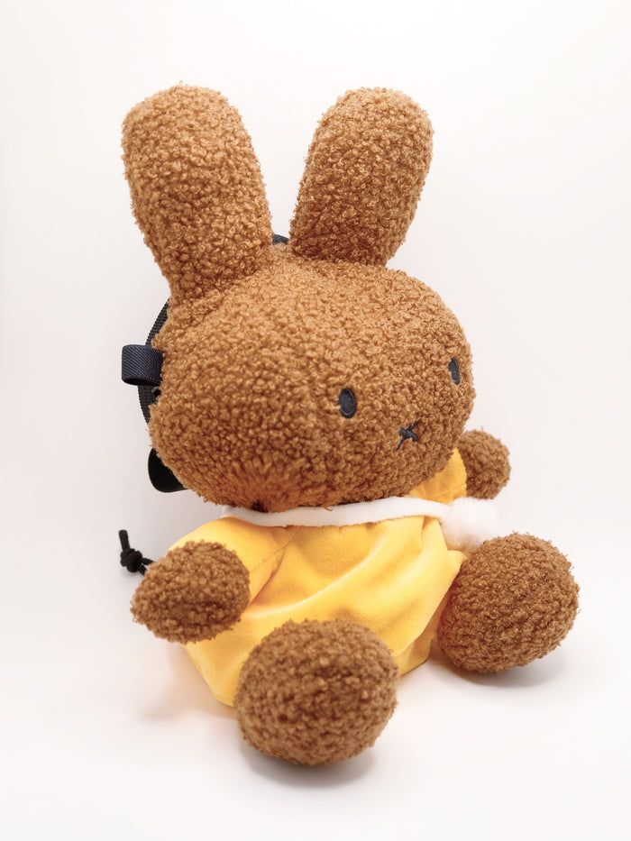 A cute anime plush chalk bag by FATWORM featuring a brown Mocha Bunny wearing a yellow dress. This functional and fluffy bouldering accessory is handmade for bouldering and climbing for rock climbing, offering a long-durable design that makes the perfect climbing gift for a climber.