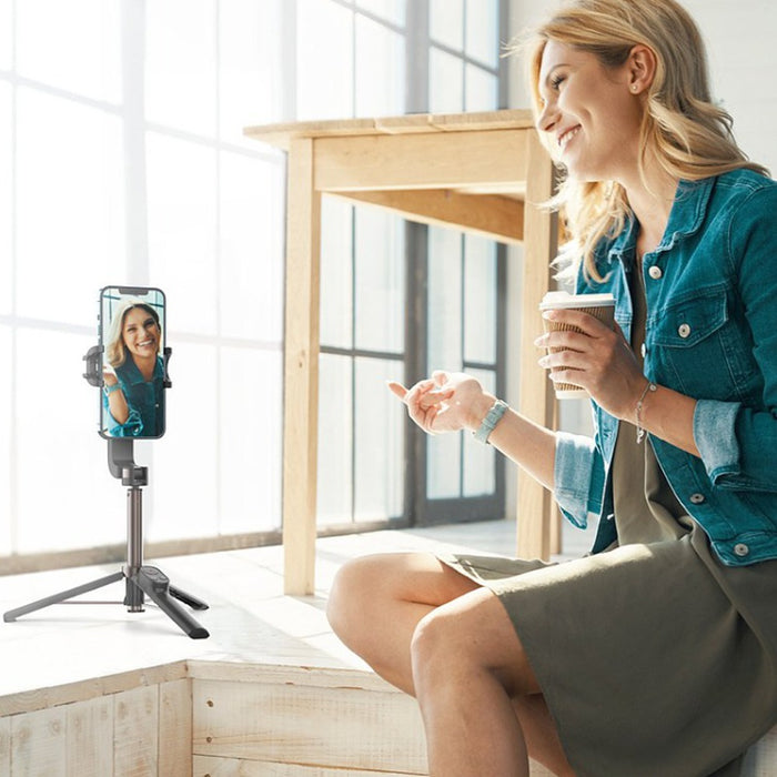 women using Momax One Click Rotation Selfie Stable to capture video