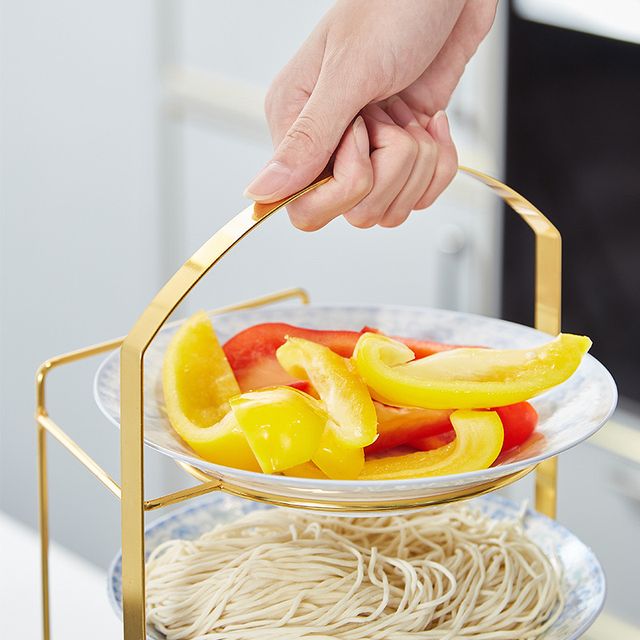 Someone is holding the Multi-Layer Wall Mount Kitchen Side Dish Storage Rack