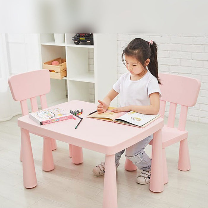 A Girls Studying in a Multi-Purpose Kids Table and Chair Set.