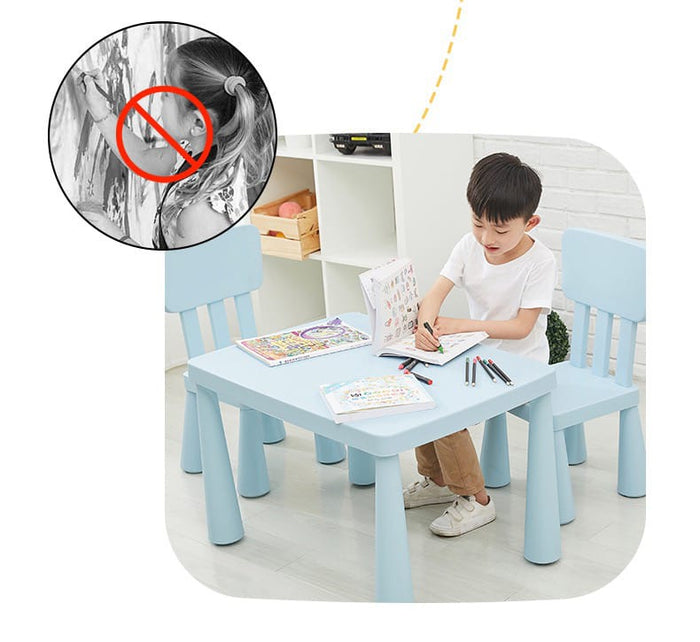 A Boys is Sitting and Drawing on Multi-Purpose Kids Table and Chair Set.