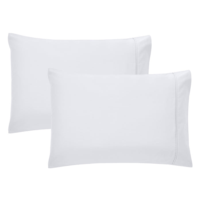 Hands touching a white 100% cotton pillowcase of a high-thread-count by California Design Den.