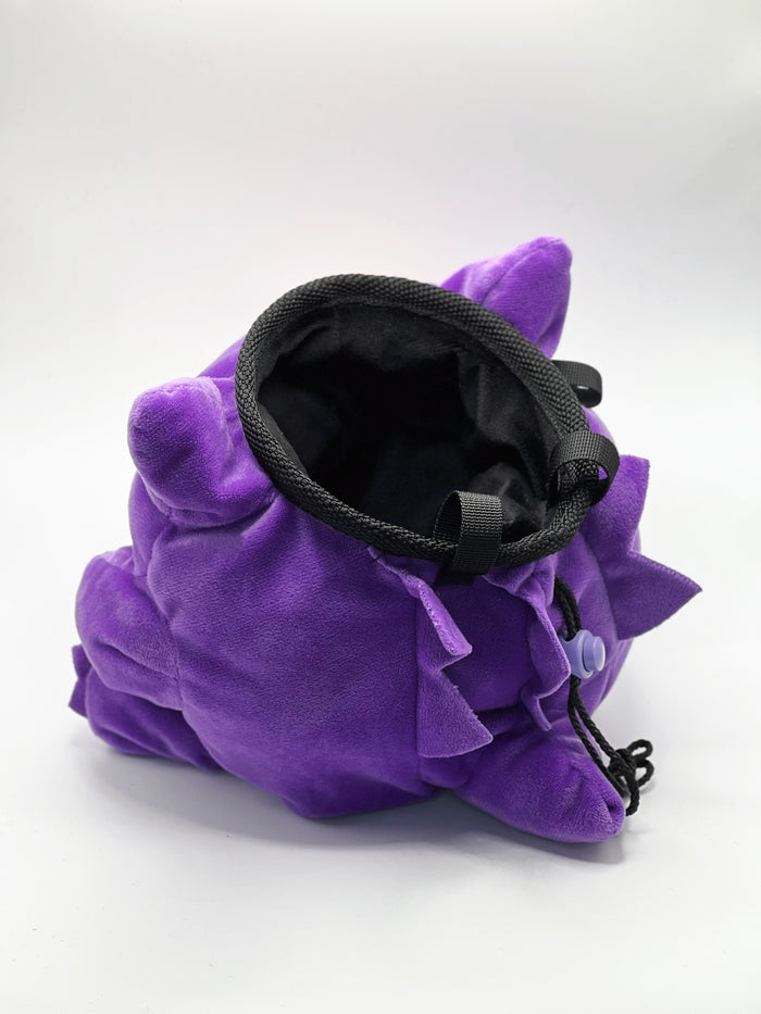 A cute anime plush chalk bag by Fatworm featuring Gengar holding a peanut. This functional and fluffy accessory is handmade for bouldering and climbing for rock climbing, offering a long-durable design that makes the perfect climbing gift for a climber.