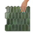 Hexagonal green tile with a hand touching it on a white background
