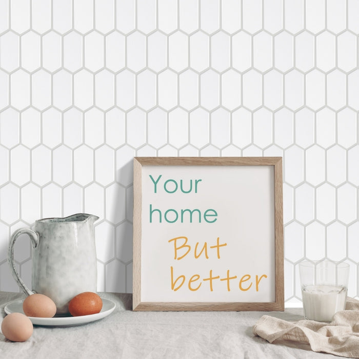 Framed print with 'Your home But better' text on a kitchen counter with eggs and a pitcher.