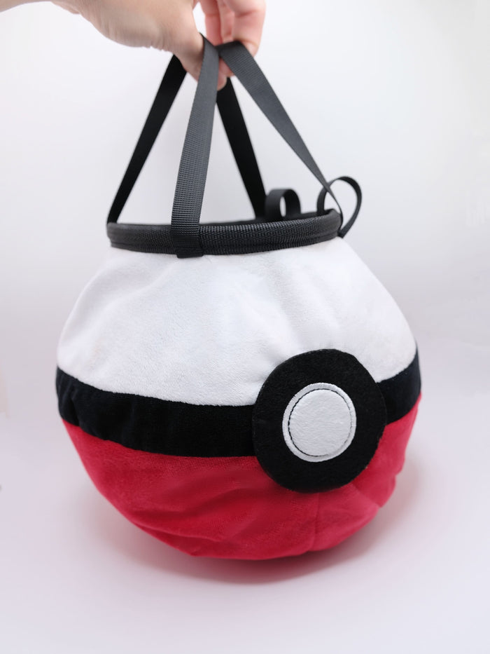 A soft and fluffy Poke Ball plush chalk bag by Fatworm. This cute yet functional climbing gear features the iconic red, white, and black design in a long-durable handmade construction. The perfect climbing gift for climbers who love gaming accessories.