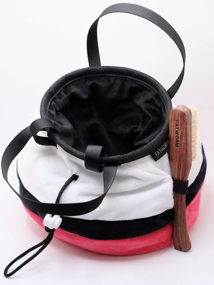 A soft and fluffy Poke Ball plush chalk bag by Fatworm. This cute yet functional climbing gear features the iconic red, white, and black design in a long-durable handmade construction. The perfect climbing gift for climbers who love gaming accessories.